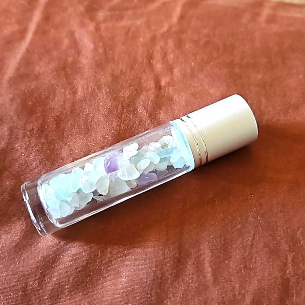 Empty glass roll on bottle with Rainbow Fluorite chips inside